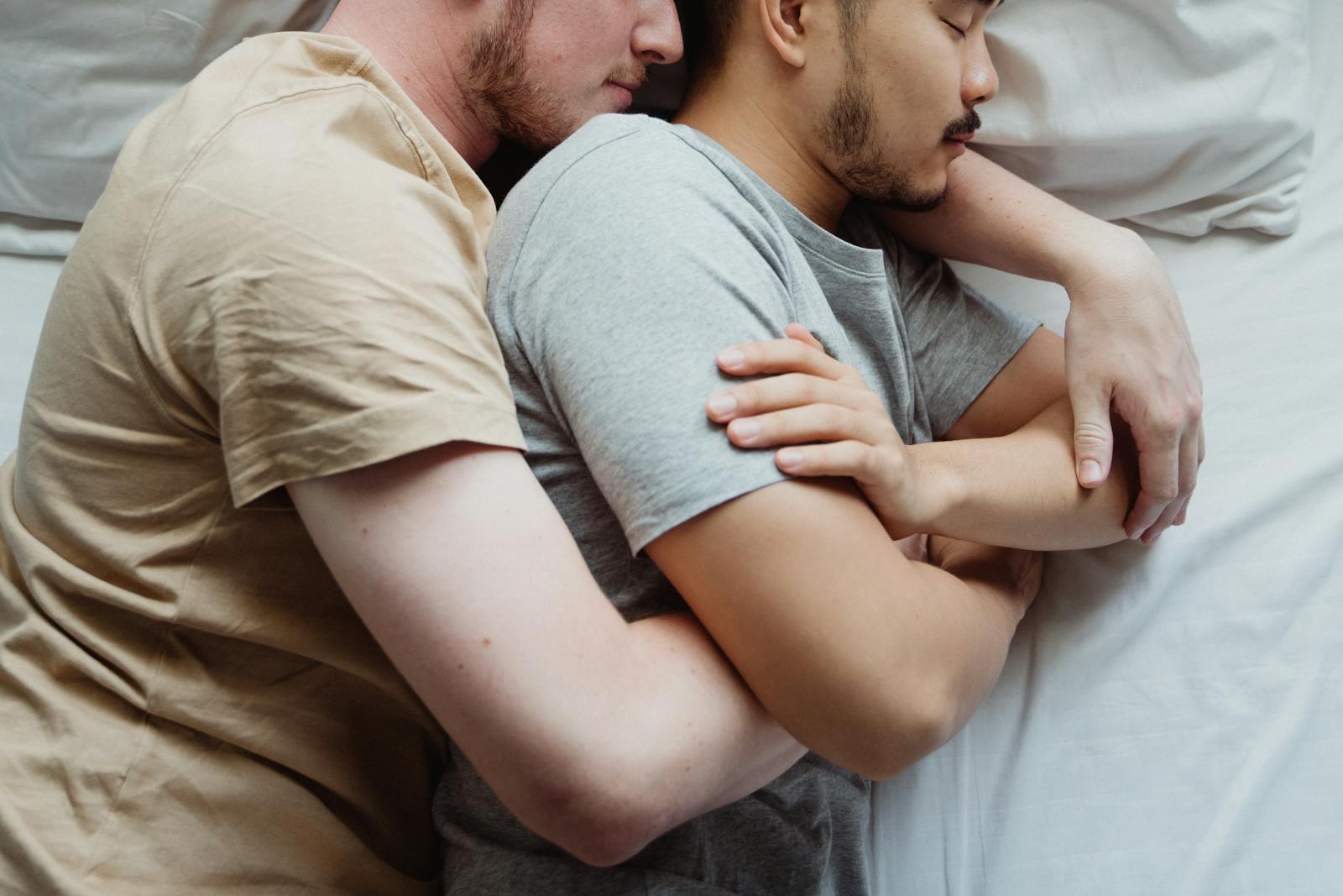 Two Men Cuddling in Bed
